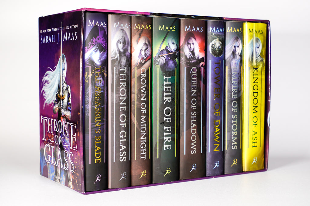 Angled view of all eight original-cover Throne of Glass hardcovers tucked inside the illustrated 2018 collector box