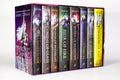Angled view of all eight original-cover Throne of Glass hardcovers tucked inside the illustrated 2018 collector box