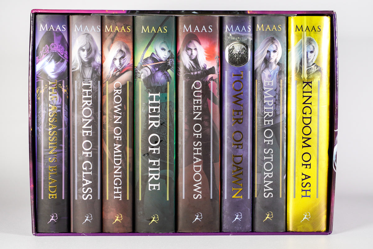 Straight-on view of all eight original-cover Throne of Glass hardcover spines inside the 2018 collector box
