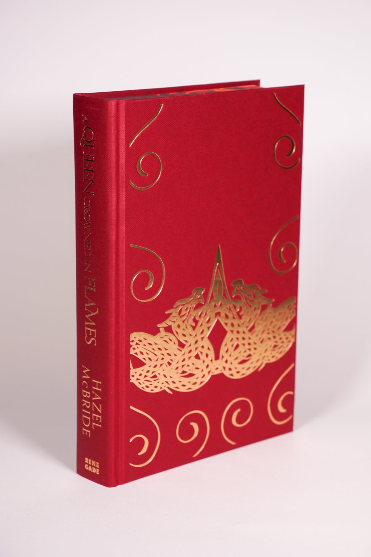 A Queen Crowned in Flames red casebound hardcover beneath the dust jacket