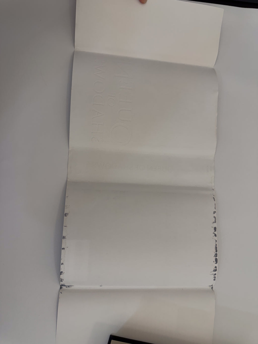 Queen of Shadows dust-jacket interior showing black color transfer