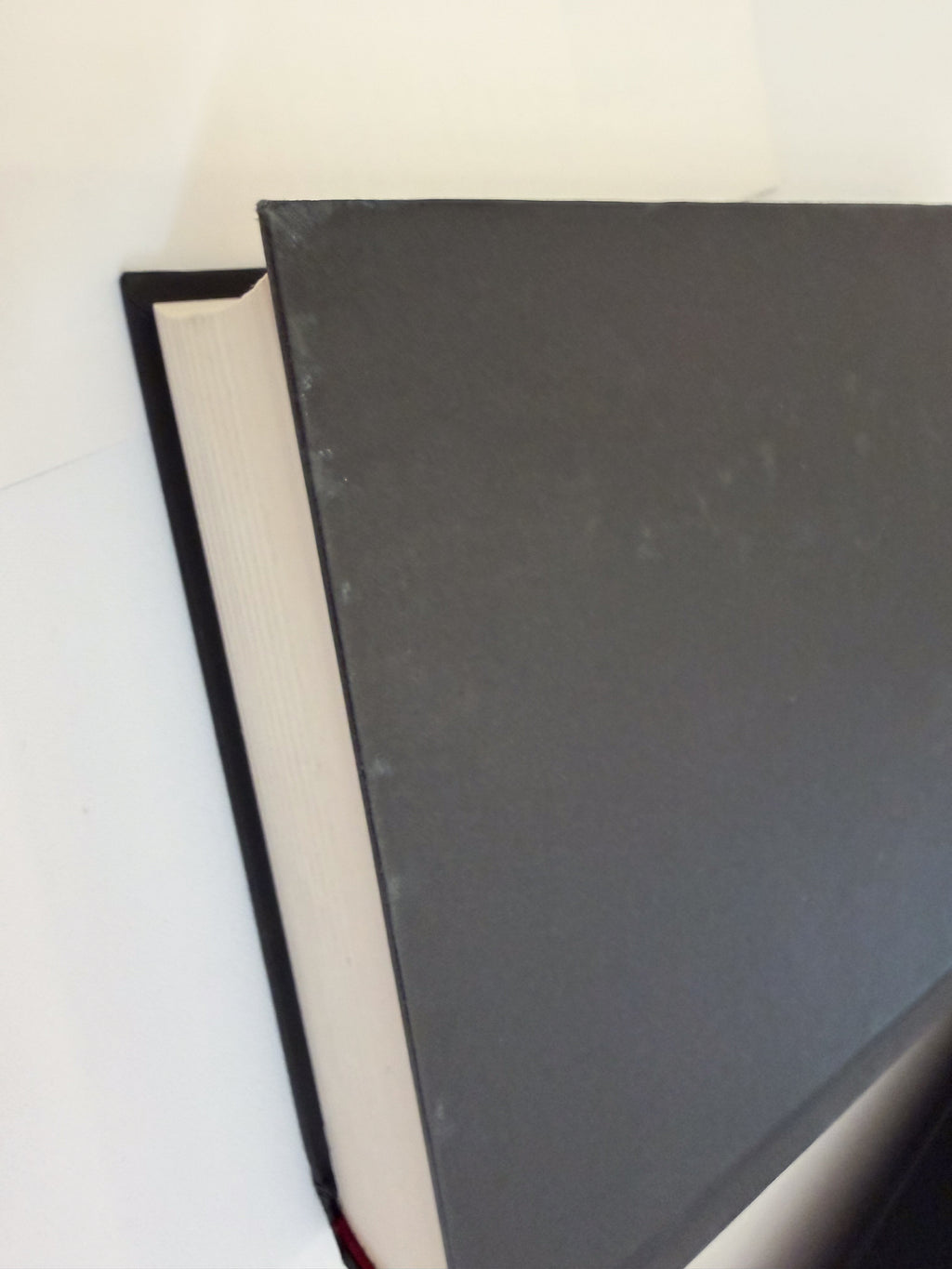 Queen of Shadows black hardcover board showing surface rubbing