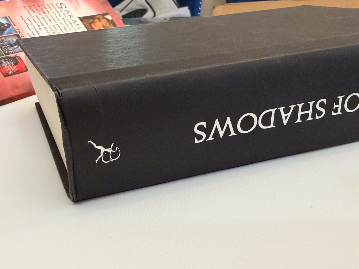 Queen of Shadows black hardcover spine and board-corner wear