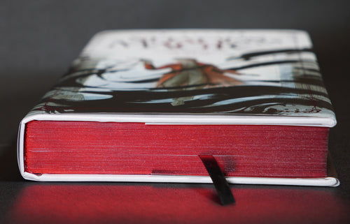 Metallic red page edges and black ribbon bookmark on the Wraithmarked edition of A Darker Shade of Magic