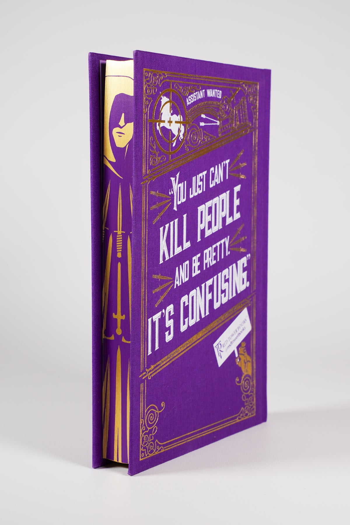 Assistant to the Villain Clothbound Edition purple and gold hardcover back