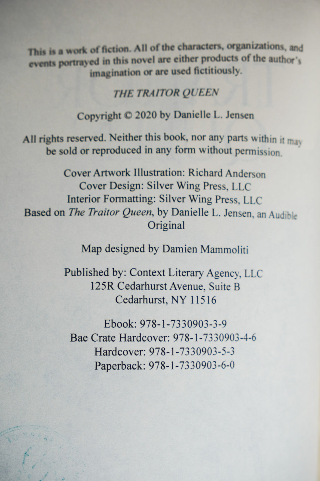 The Bridge Kingdom and The Traitor Queen — original-cover paperback pair: Traitor Queen copyright and ISBN details; actual copy