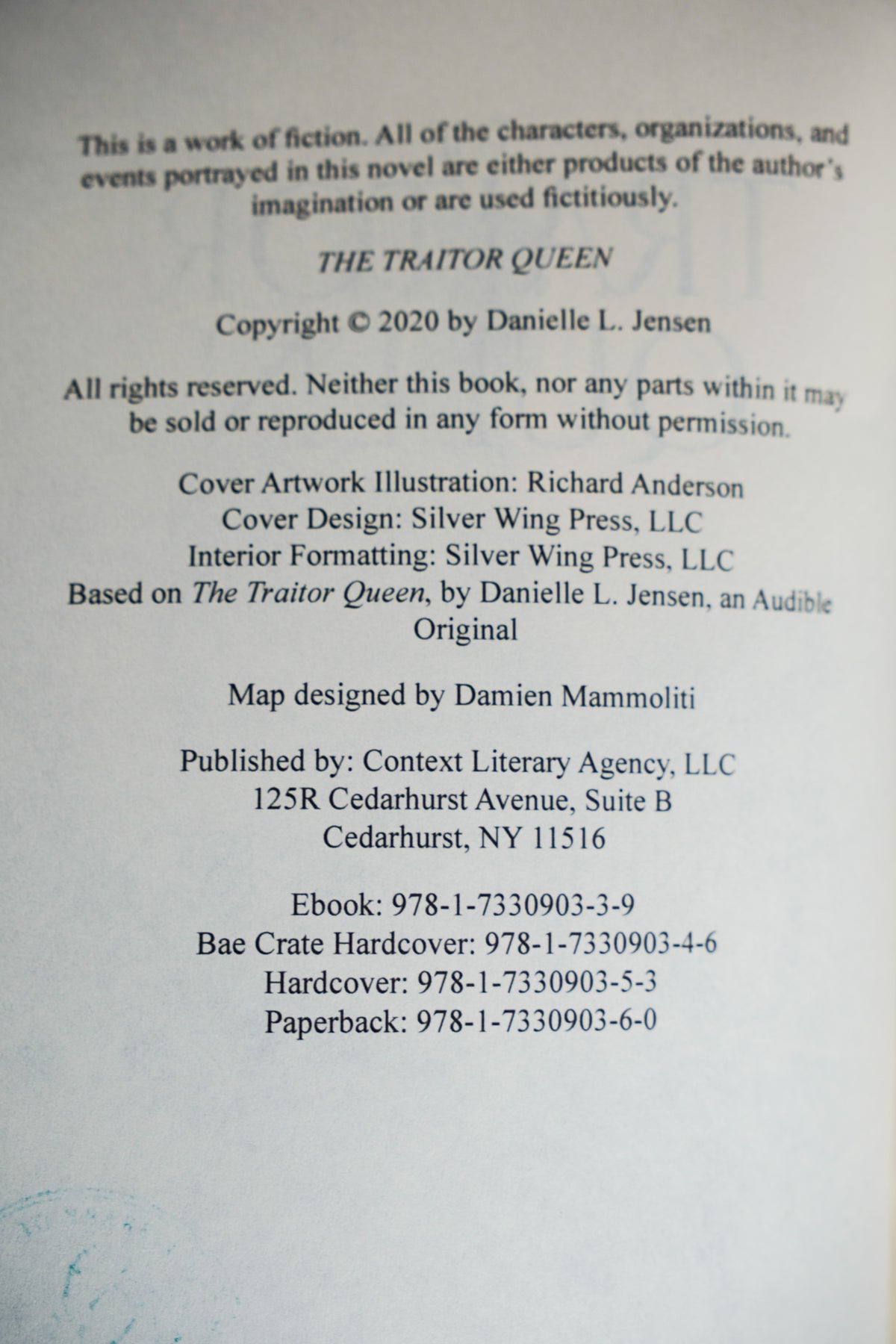 The Bridge Kingdom and The Traitor Queen — original-cover paperback pair: Traitor Queen copyright and ISBN details; actual copy