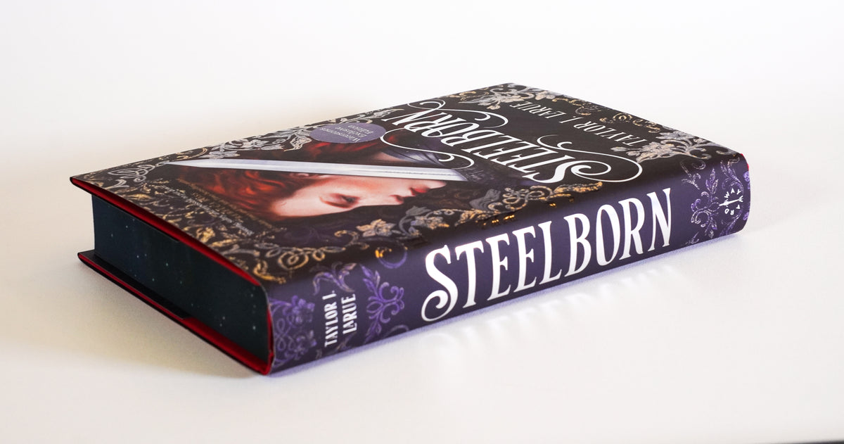 Steelborn Waterstones Exclusive Edition lying flat, showing the dust jacket, spine and sprayed edges