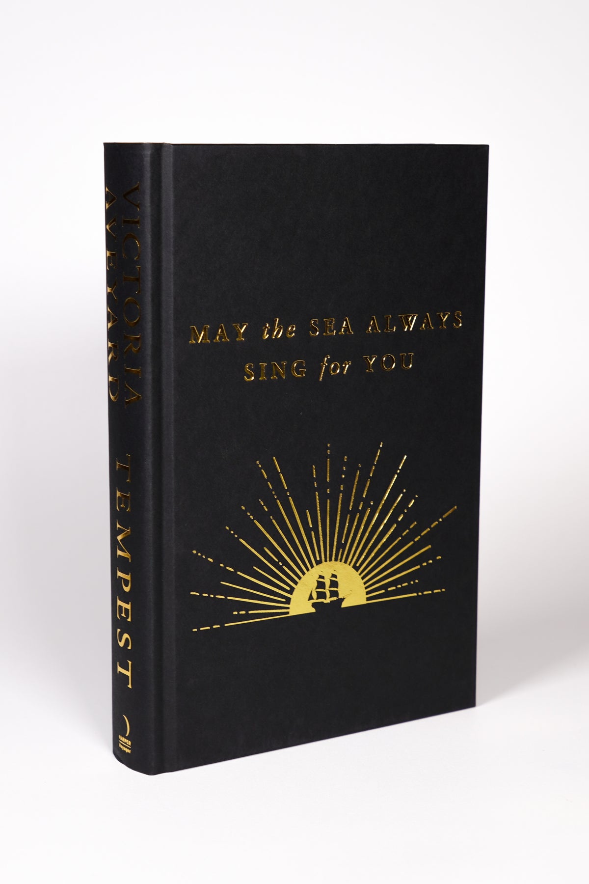 Bright finished view of the Tempest black hardcover with gold foil ship design