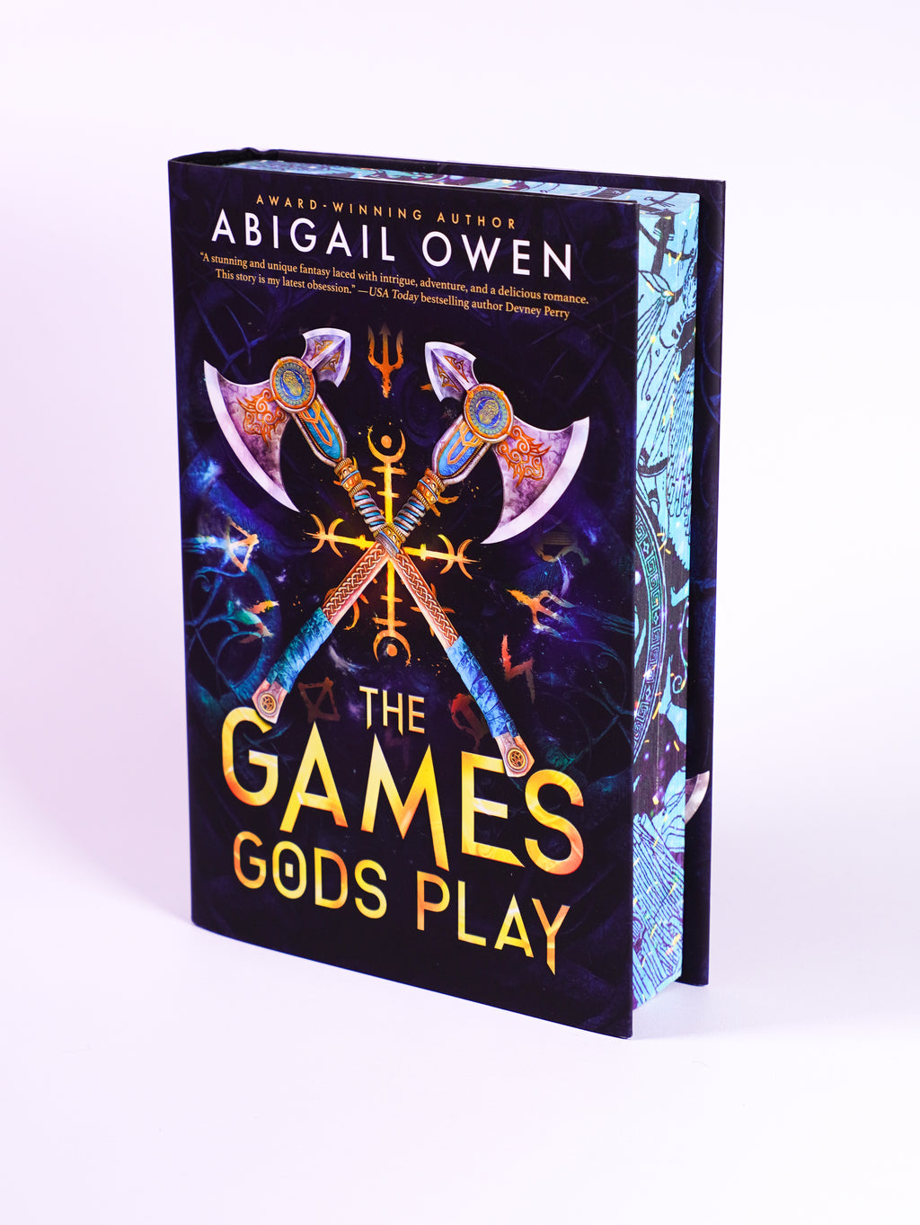 The Games Gods Play deluxe hardcover by Abigail Owen, front dust jacket and blue illustrated page edges