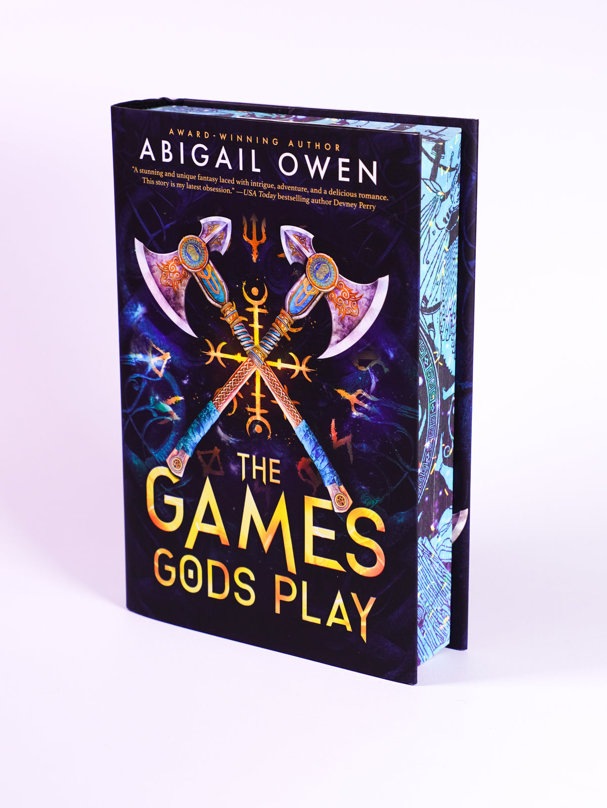 The Games Gods Play deluxe hardcover by Abigail Owen, front dust jacket and blue illustrated page edges
