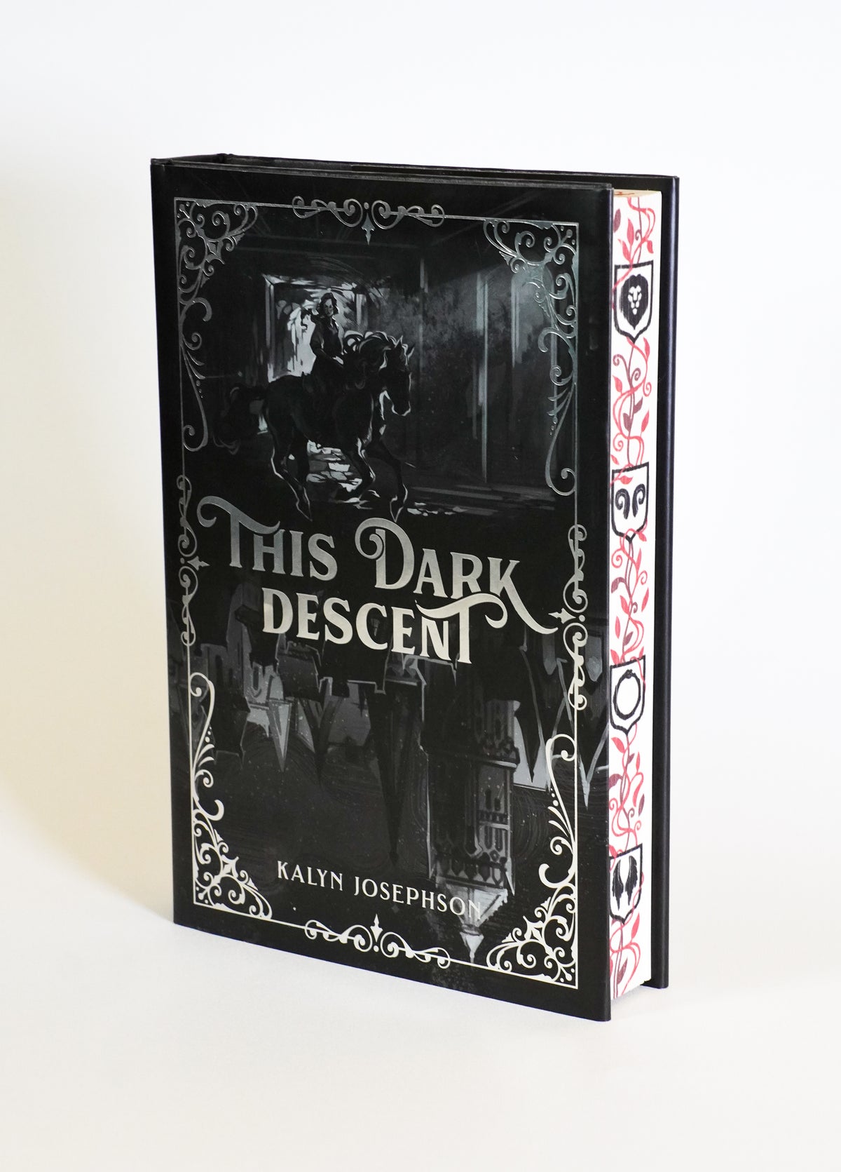 This Dark Descent OwlCrate edition, showing the illustrated dust jacket and red-and-black decorated fore-edge