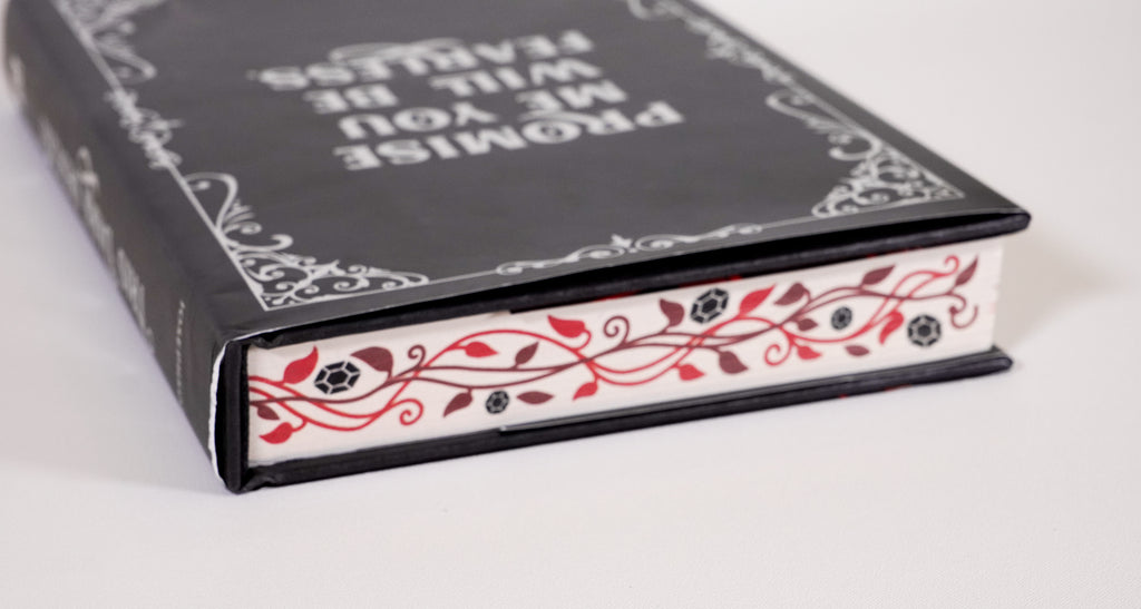 Opposite decorated page-edge detail on This Dark Descent, with the book lying flat