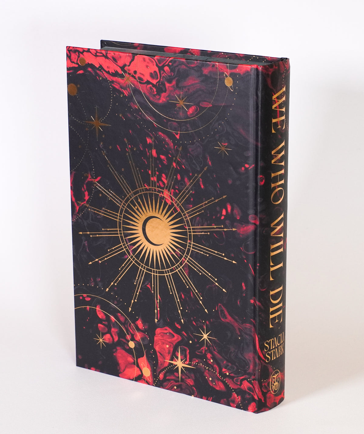 We Who Will Die FairyLoot edition without the dust jacket, showing the celestial gold foil design on the back hardcover and spine