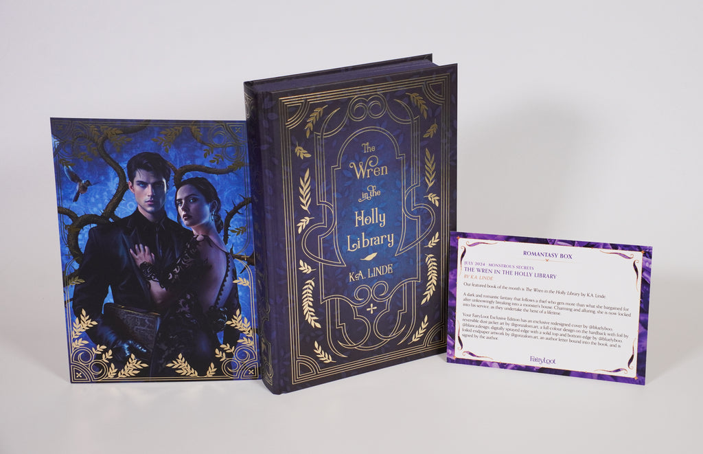 The Wren in the Holly Library FairyLoot edition, showing the blue-and-gold hardcover beside a character-art print and July 2024 edition information card